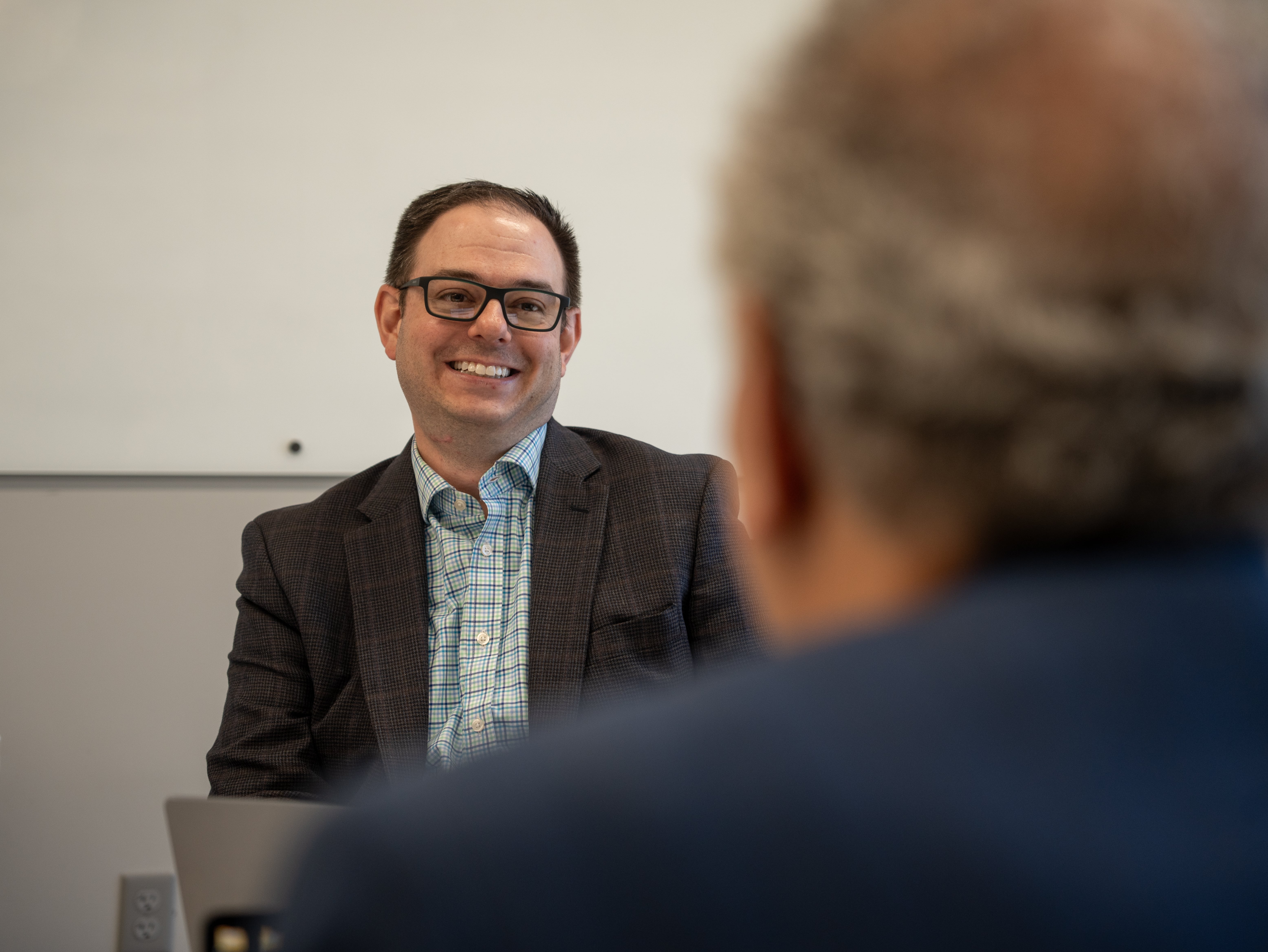 Michael Licari Smiling in a Meeting